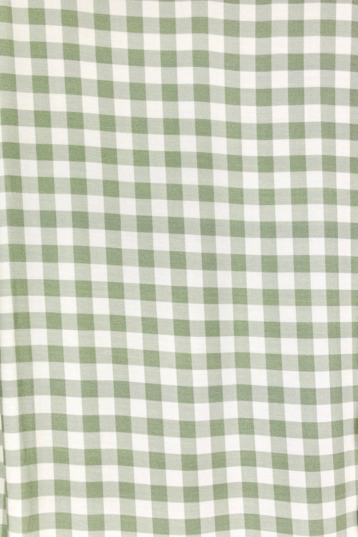 Evergreen lane swaddle in a light green and white gingham bamboo fabric.