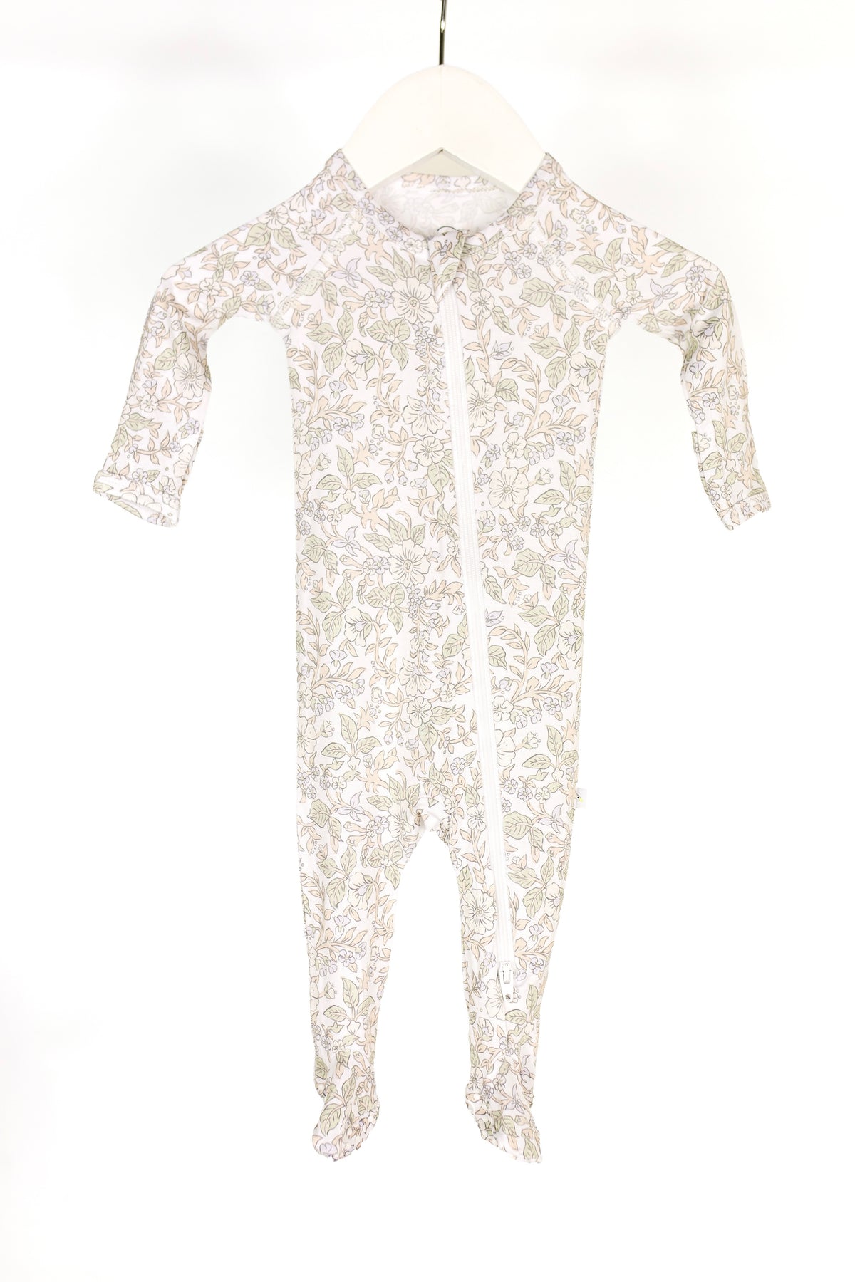 A long-sleeve, footed “heirloom / one piece zipper” baby onesie featuring a light floral pattern and a diagonal zipper is displayed on a white hanger against a white background.