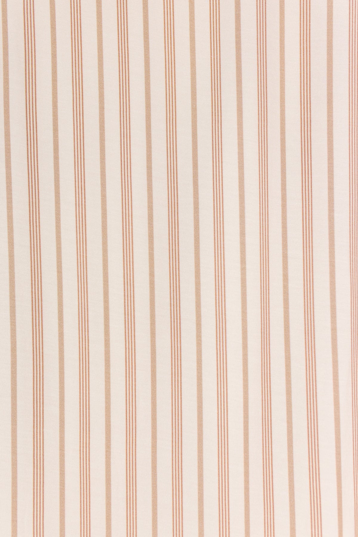 Toast and Honey / Swaddle features a beige fabric background adorned with evenly spaced vertical tan and cream stripes, creating a simple, minimalist pattern.