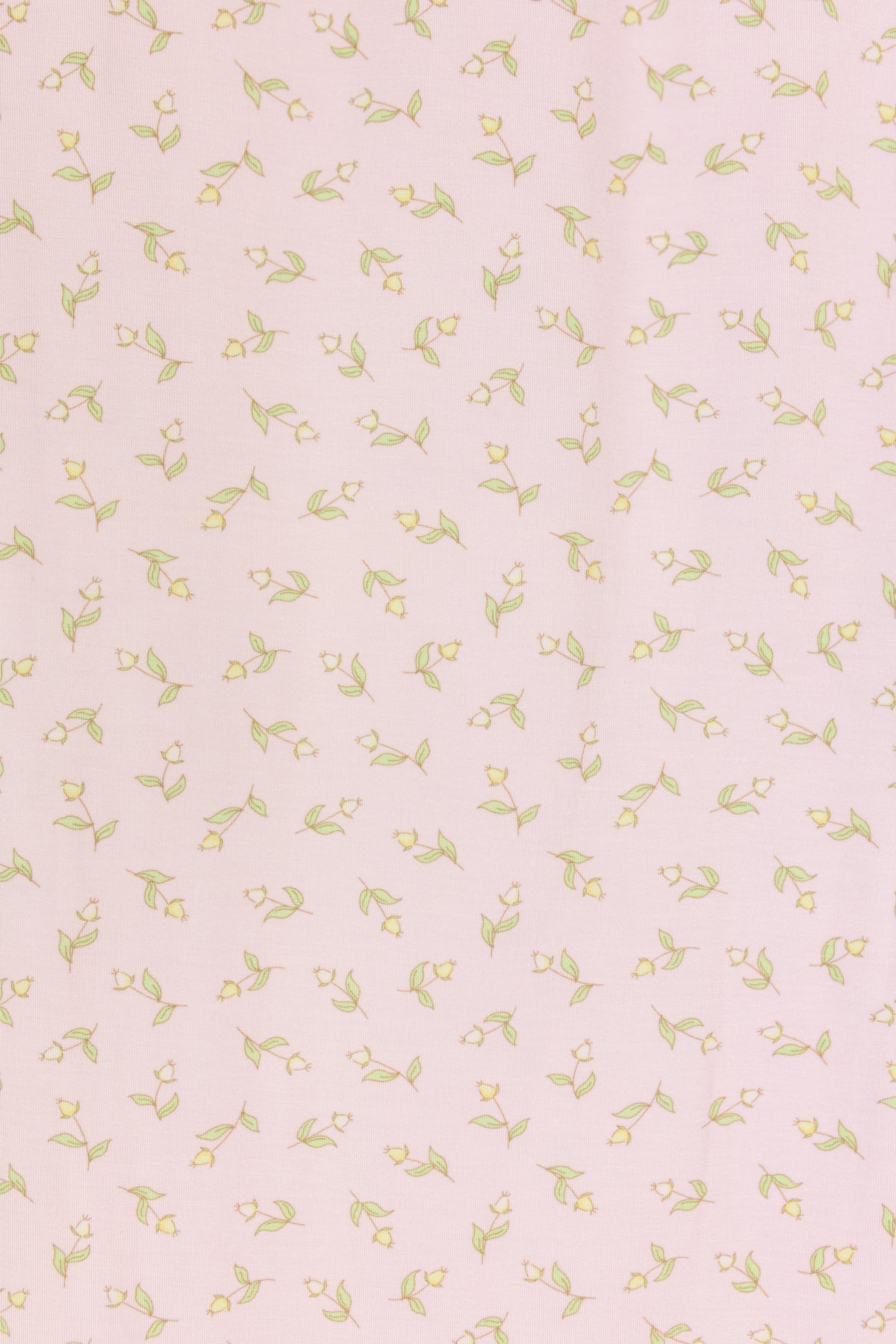 Featuring a pink background with an evenly scattered pattern of small yellow flowers and green leaves, the rosebud / swaddle is perfect for a cozy pink baby blanket or a charming rosebud print swaddle.