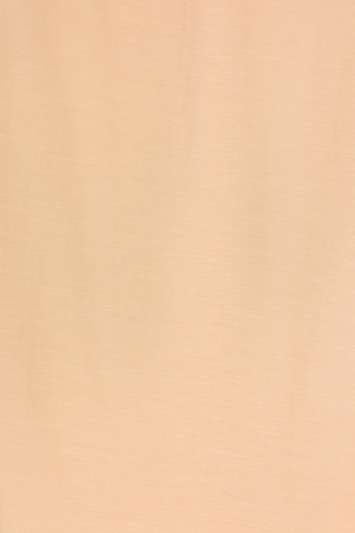 A close-up of the whisp / swaddle’s smooth, light beige fabric surface with a subtle, fine texture, reminiscent of a single layered swaddle. No visible patterns, wrinkles, or additional objects; the background is plain and uniform.