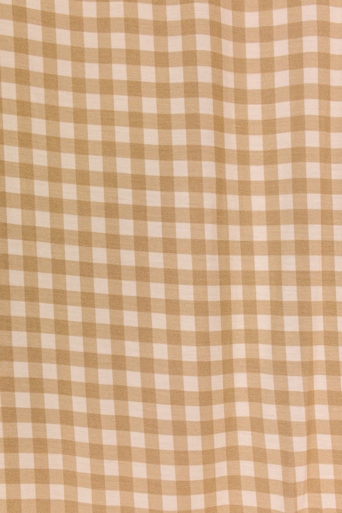 The teddy bear check / swaddle features a beige and white gingham pattern with evenly spaced vertical and horizontal stripes, creating a classic checkered design. The fabric has a soft texture and gentle folds.
