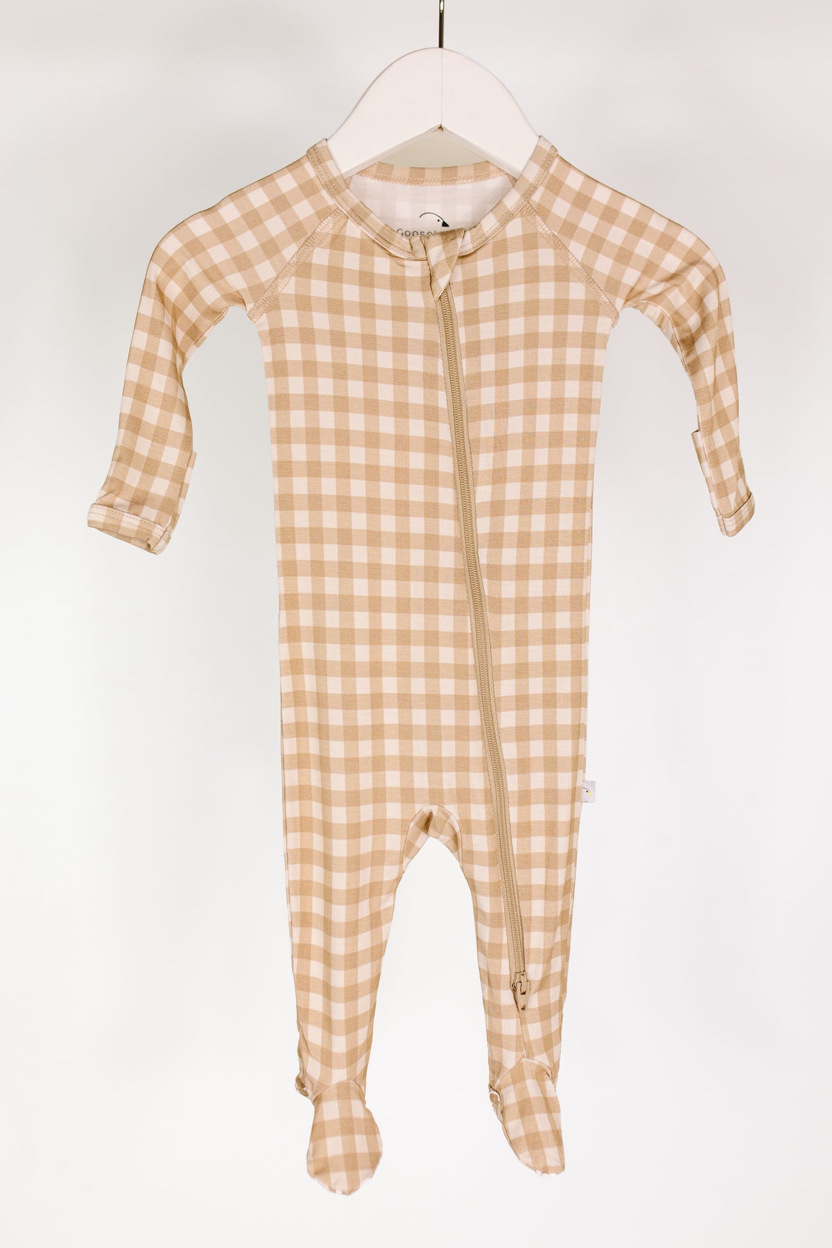 Beige and white teddy bear check one piece zipper with long sleeves and covered feet, displayed on a white hanger against a plain background—perfect as cozy footed pajamas or a newborn zipper onesie for ultimate comfort.