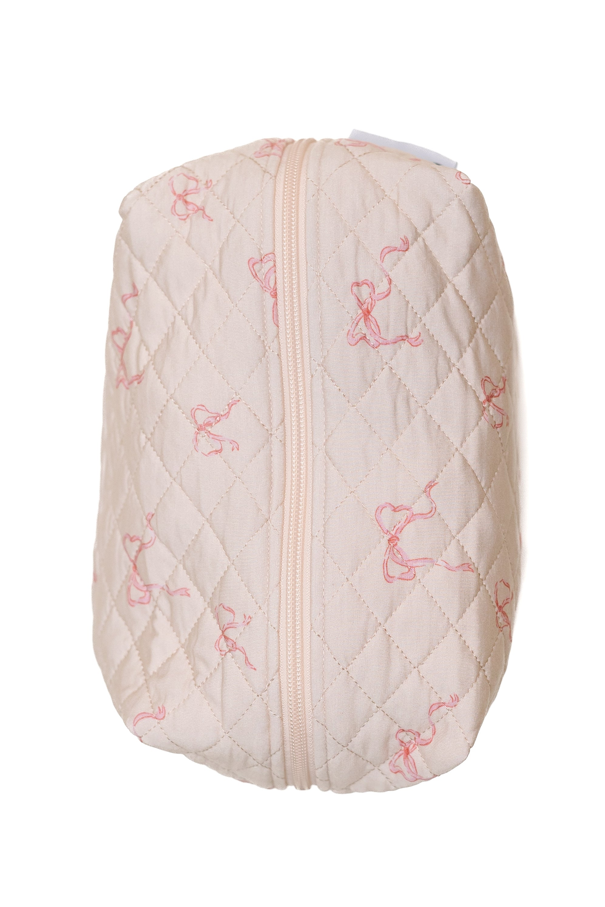 The ballerina travel bag is a quilted, cream-colored bamboo pouch featuring a diamond pattern and light pink ribbon designs—blending elegance and function for your travels.