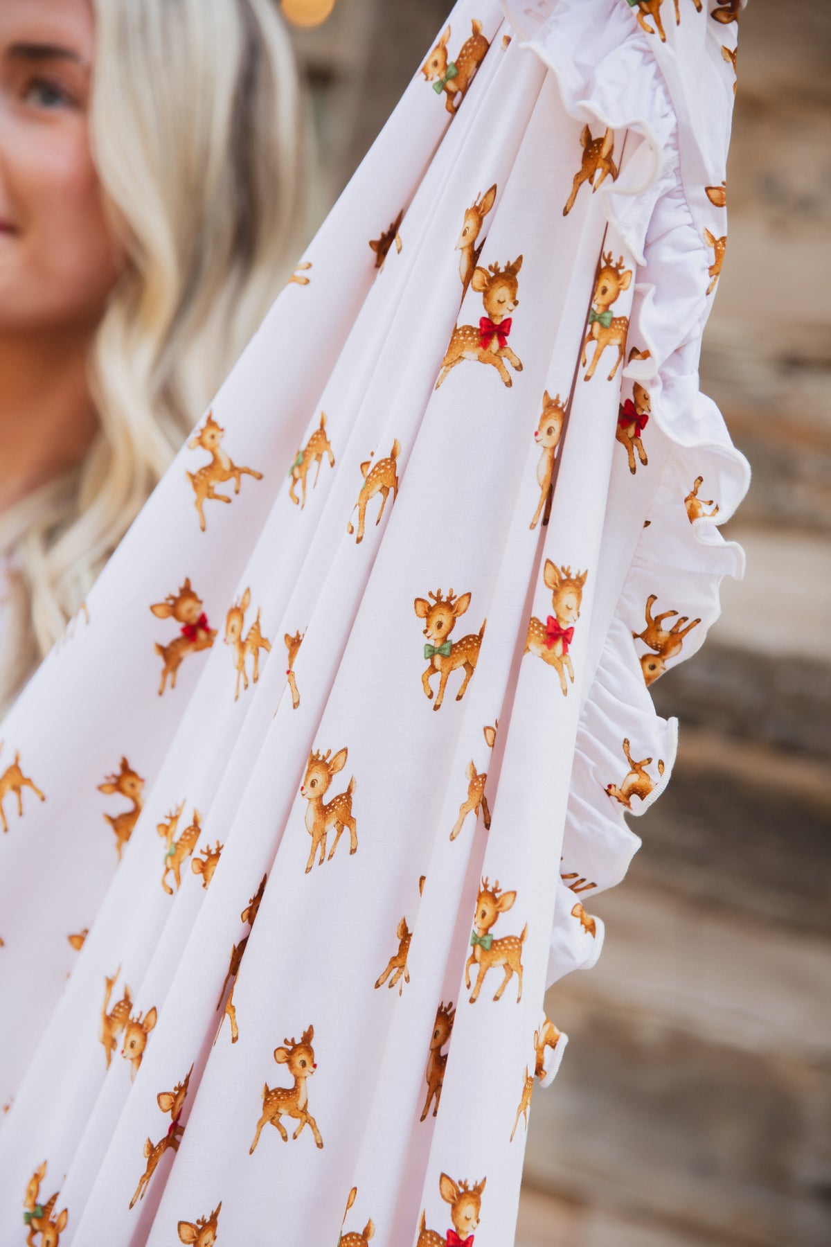 Light pink luxurious bamboo vintage reindeer / ruffle blanket with a ruffled edge.