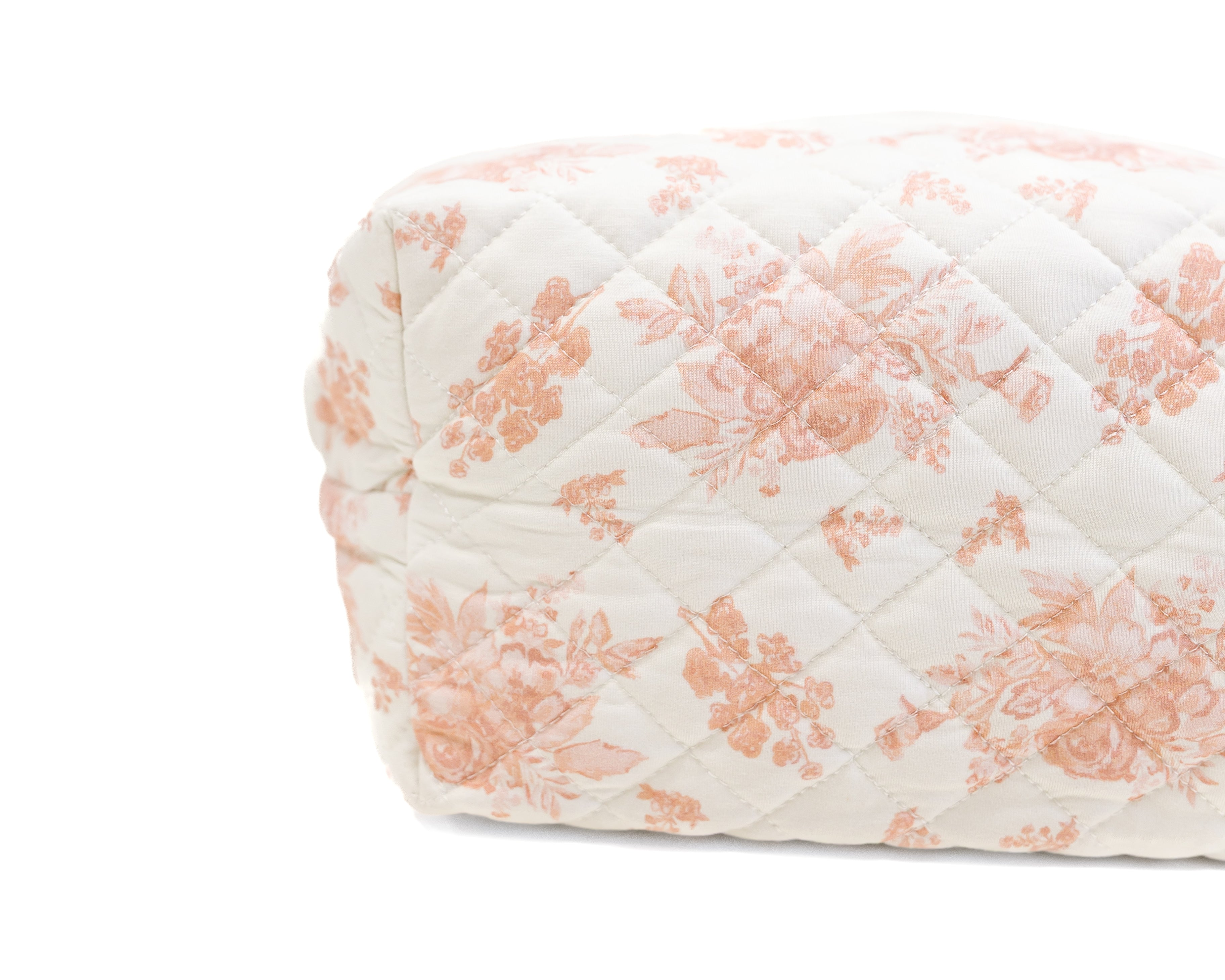 The romance / travel bag features a quilted floral print with pink flowers on a white background, displayed against a plain white surface.